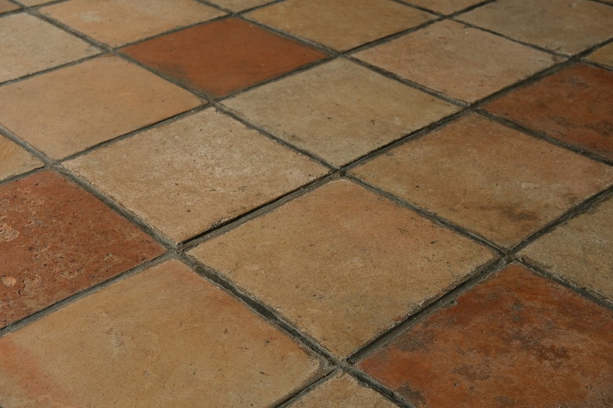 Close-up of warm red terracotta-look floor tiles
