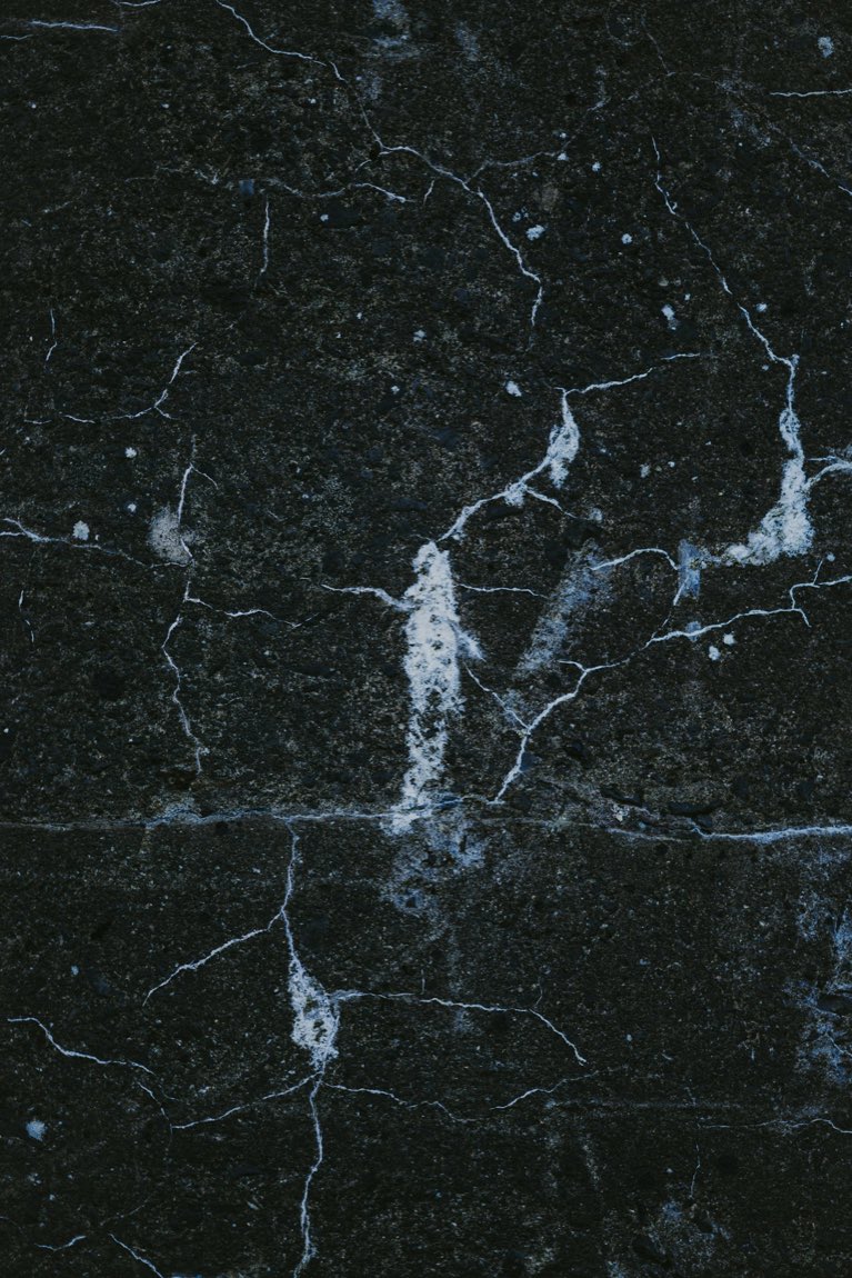 Close-up of near-black marble-look porcelain with fine white veining